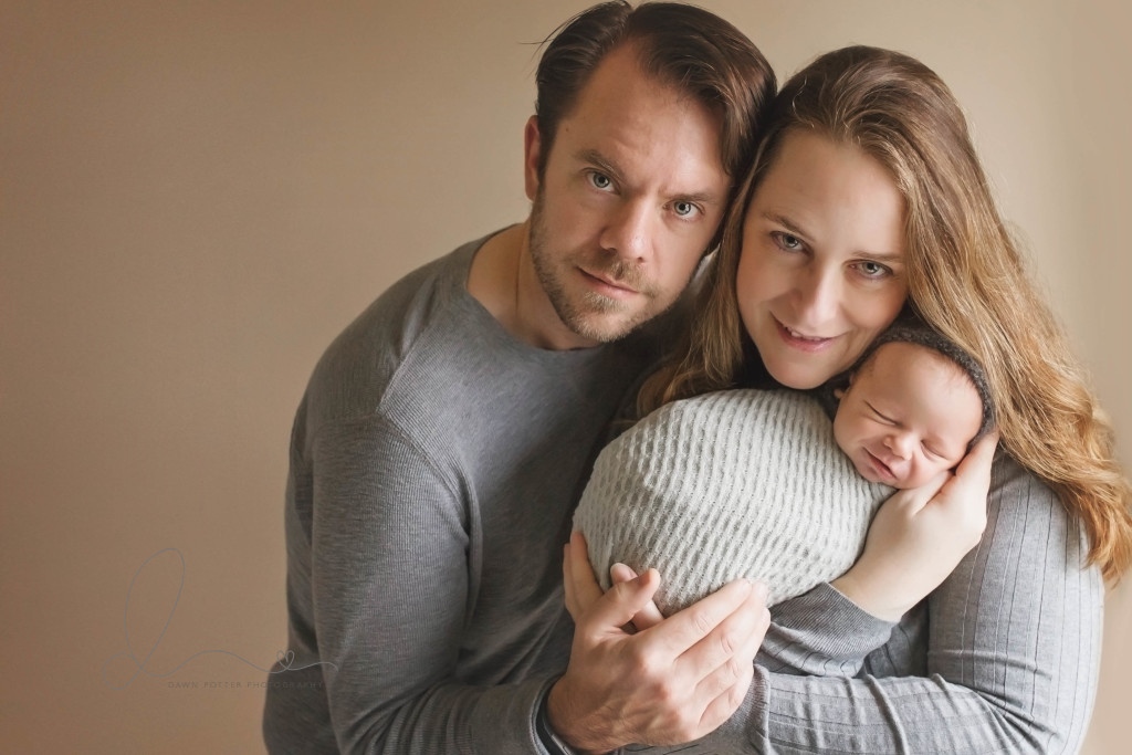 smiling baby boy | baby boy wrapped with mom and dad | issaquah baby photographer