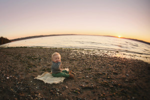 baby boy on the beach with fisheye lens