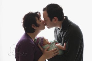 mom and dad with newborn baby | backlit | Seattle newborn photography