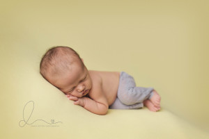 side lying pose | baby girl on yellow | Seattle newborn photography