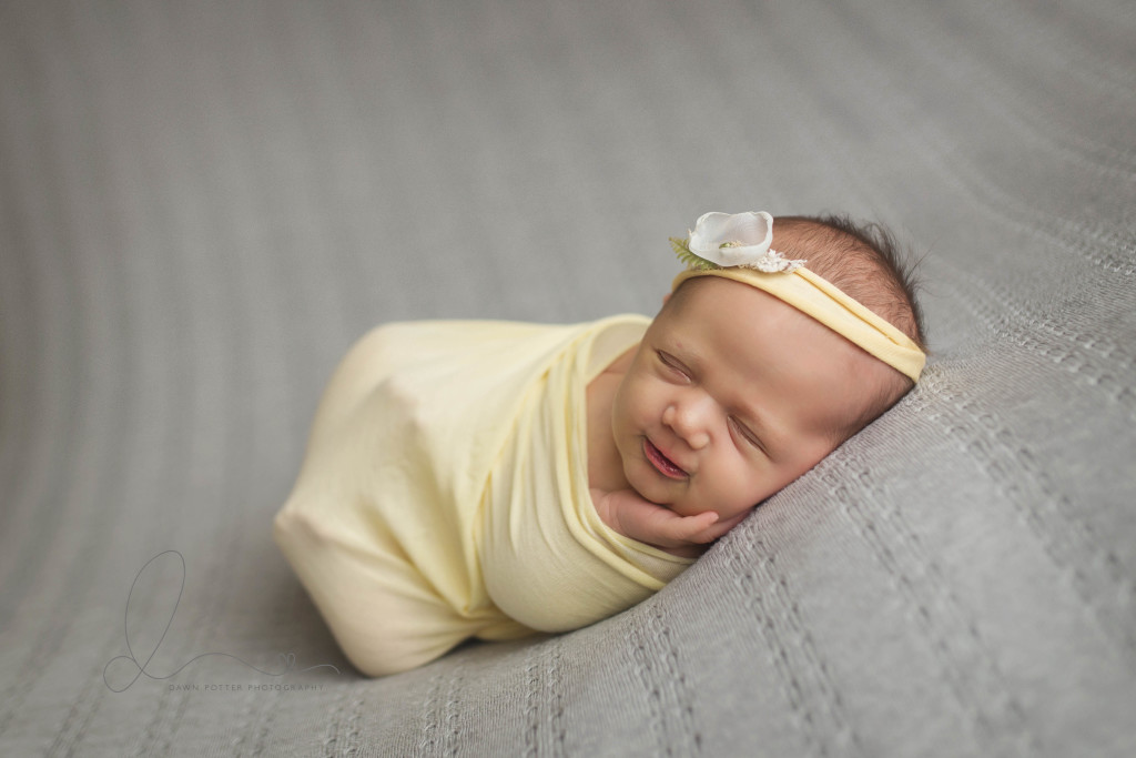 wrapped smiling baby pose | baby girl on grey | Seattle newborn photography