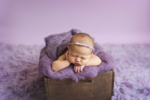 baby in purple in crate | Seattle newborn photography