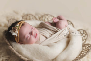 enumclaw newborn photographer | baby in basket smiling