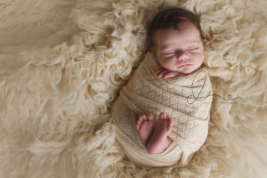 enumclaw newborn photographer | baby wrapped on flokati