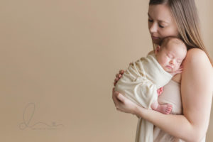 Seattle newborn baby girl wrapped with mom